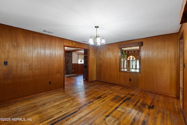 unfurnished dining area featuring hardwood / wood-style floors, visible vents, and plenty of natural light