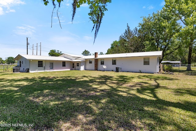 back of house with a yard and fence