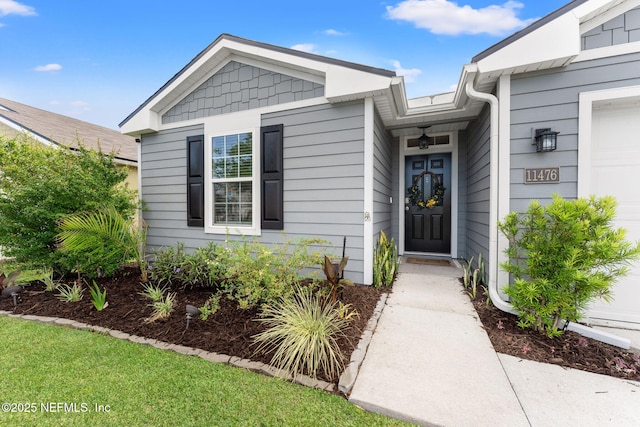 11476 Sheepshead Ln, Jacksonville, FL 32226 - view of exterior entry featuring an attached garage