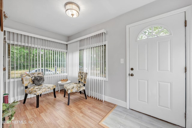 foyer featuring baseboards and light wood-type flooring