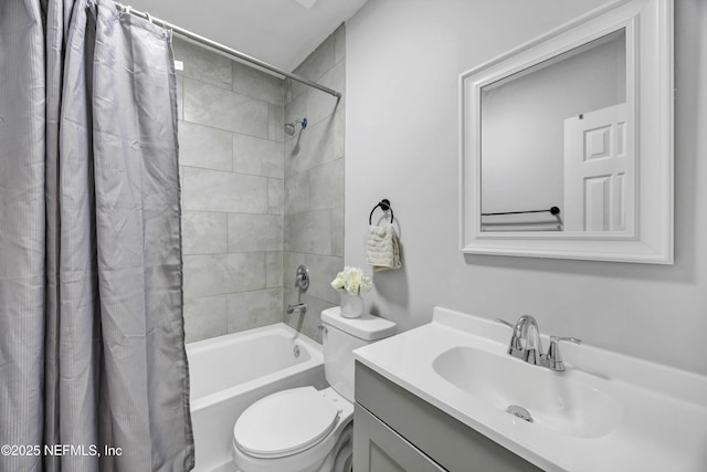 bathroom with vanity, shower / bath combination with curtain, and toilet