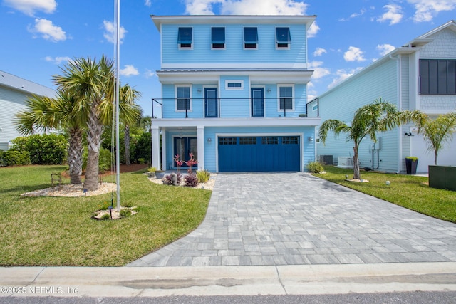 548 Sea Island Dr, Fernandina Beach, FL 32034 - beach home featuring a balcony, a front yard, a garage, and decorative driveway