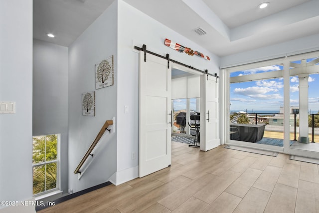 548 Sea Island Dr, Fernandina Beach, FL 32034 - spare room with a barn door, wood finished floors, baseboards, and recessed lighting