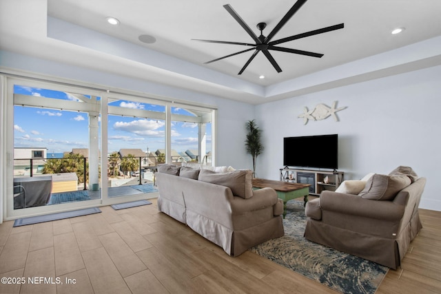 548 Sea Island Dr, Fernandina Beach, FL 32034 - living area featuring a raised ceiling, ceiling fan, wood finished floors, and recessed lighting
