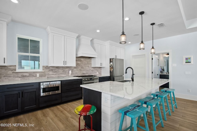 548 Sea Island Dr, Fernandina Beach, FL 32034 - kitchen featuring custom range hood, a sink, freestanding refrigerator, decorative backsplash, and recessed lighting