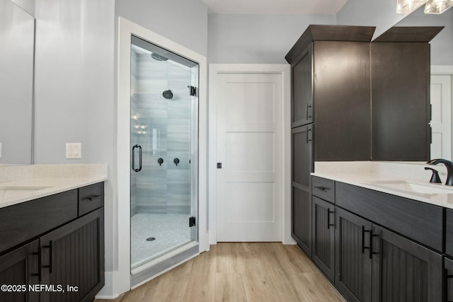548 Sea Island Dr, Fernandina Beach, FL 32034 - full bath featuring a stall shower, wood finished floors, and two vanities