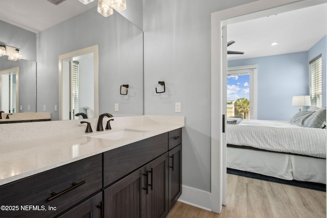 548 Sea Island Dr, Fernandina Beach, FL 32034 - full bath with ensuite bathroom, baseboards, wood finished floors, and vanity