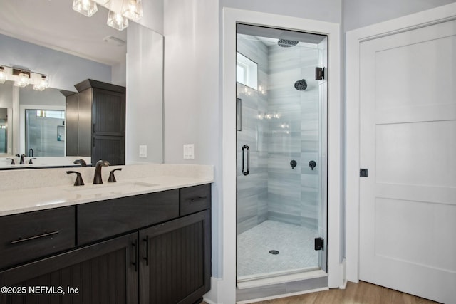 548 Sea Island Dr, Fernandina Beach, FL 32034 - full bathroom with a stall shower, wood finished floors, and vanity