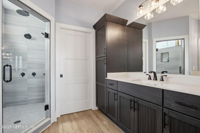 548 Sea Island Dr, Fernandina Beach, FL 32034 - bathroom with wood finished floors, a stall shower, and vanity