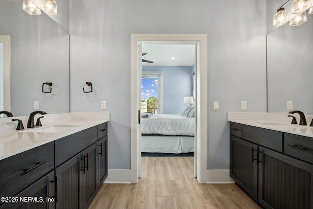 548 Sea Island Dr, Fernandina Beach, FL 32034 - full bath with ensuite bathroom, wood finished floors, baseboards, and two vanities