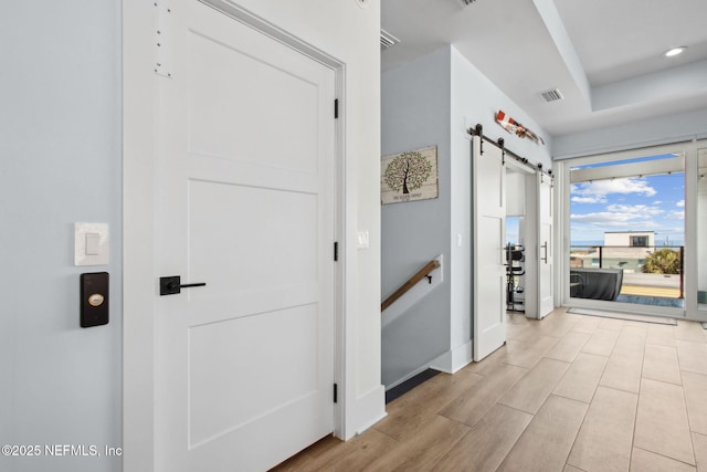548 Sea Island Dr, Fernandina Beach, FL 32034 - corridor featuring a barn door, wood finished floors, baseboards, and recessed lighting