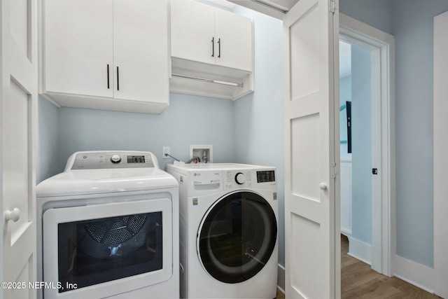 548 Sea Island Dr, Fernandina Beach, FL 32034 - clothes washing area featuring independent washer and dryer, cabinet space, wood finished floors, and baseboards
