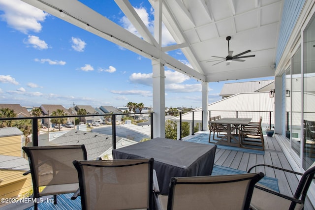 548 Sea Island Dr, Fernandina Beach, FL 32034 - wooden deck with ceiling fan, outdoor dining space, and a residential view