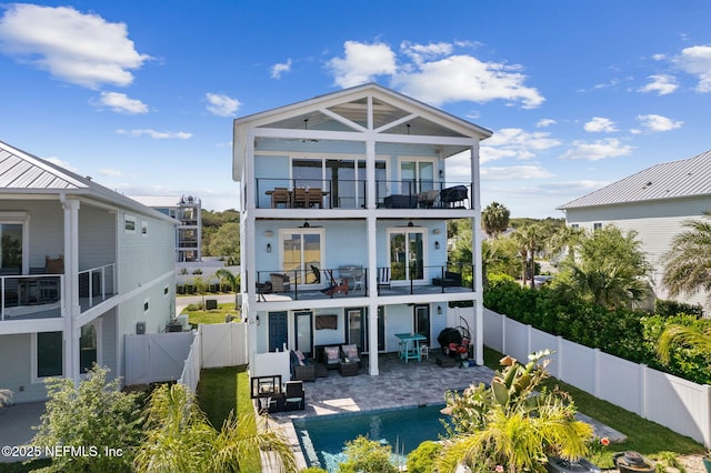 548 Sea Island Dr, Fernandina Beach, FL 32034 - rear view of house featuring a balcony, a fenced backyard, a patio area, a gate, and an outdoor hangout area