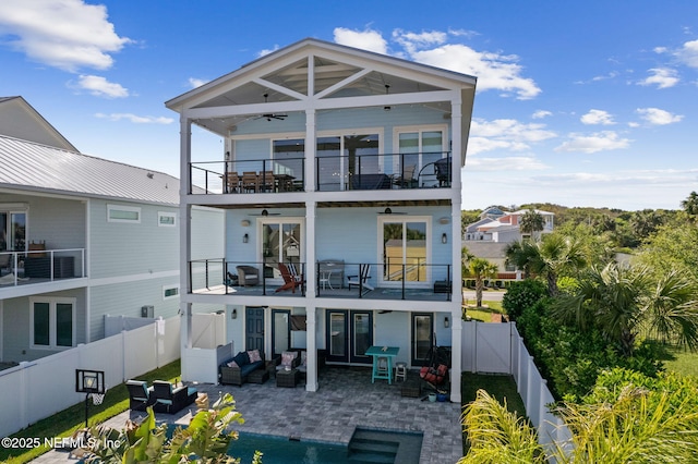 548 Sea Island Dr, Fernandina Beach, FL 32034 - back of property with a balcony, a ceiling fan, outdoor lounge area, a fenced backyard, and a patio