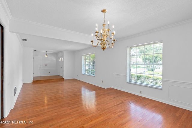 1228 Old Mill Rd, Orlando, FL 32806 - unfurnished room with visible vents, ornamental molding, baseboards, a chandelier, and light wood finished floors