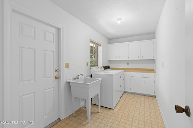 1228 Old Mill Rd, Orlando, FL 32806 - laundry room with cabinet space, baseboards, washing machine and dryer, and light floors