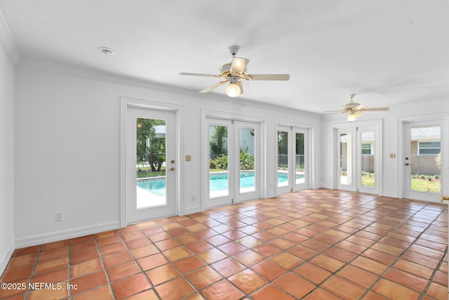 1228 Old Mill Rd, Orlando, FL 32806 - tiled spare room featuring crown molding, baseboards, ceiling fan, and a textured ceiling