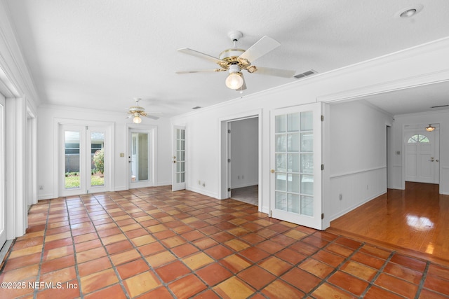 1228 Old Mill Rd, Orlando, FL 32806 - empty room featuring tile patterned flooring, ceiling fan, ornamental molding, and visible vents