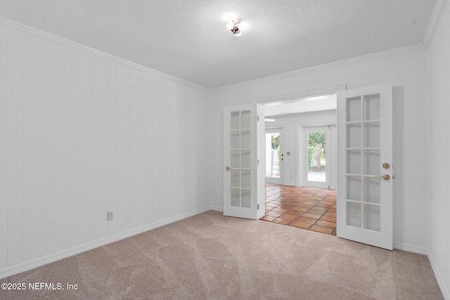 1228 Old Mill Rd, Orlando, FL 32806 - empty room with carpet floors, ornamental molding, french doors, and a textured ceiling