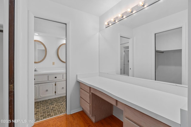 1228 Old Mill Rd, Orlando, FL 32806 - bathroom featuring vanity, baseboards, and wood finished floors
