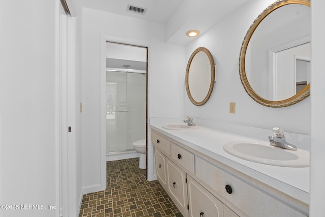 1228 Old Mill Rd, Orlando, FL 32806 - bathroom featuring visible vents, a sink, toilet, and a shower stall