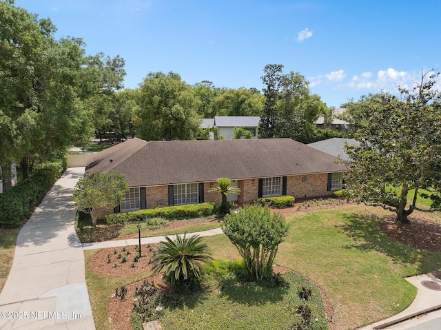 1228 Old Mill Rd, Orlando, FL 32806 - single story home with roof with shingles, a front lawn, and brick siding