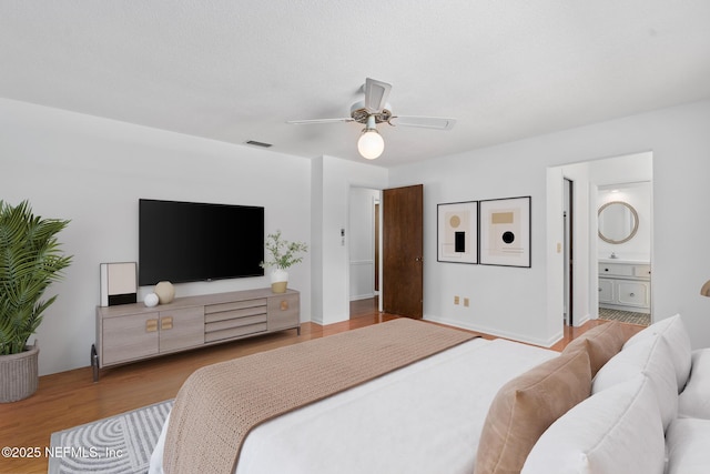 1228 Old Mill Rd, Orlando, FL 32806 - bedroom featuring connected bathroom, a ceiling fan, visible vents, and wood finished floors