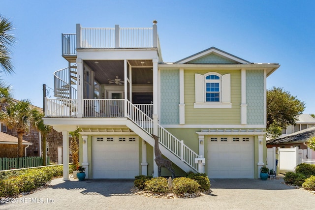 111 Cherry St, Neptune Beach, FL 32266 - view of front facade with stairway, a ceiling fan, and a garage