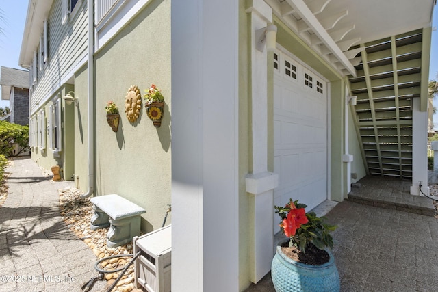 111 Cherry St, Neptune Beach, FL 32266 - view of home's exterior with an attached garage and stucco siding