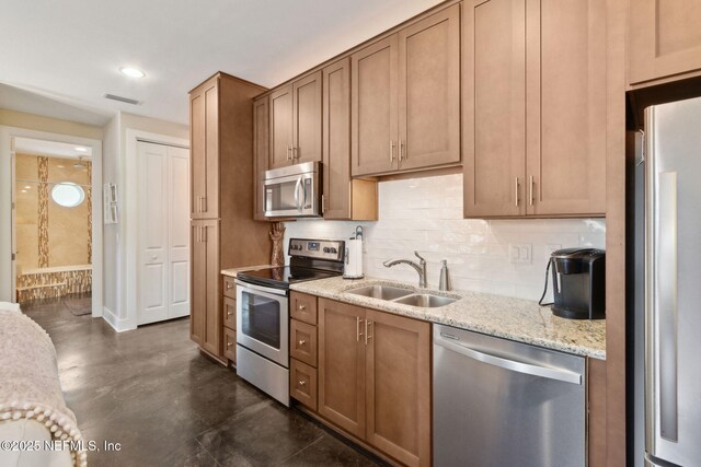 111 Cherry St, Neptune Beach, FL 32266 - kitchen featuring a sink, tasteful backsplash, visible vents, light stone countertops, and appliances with stainless steel finishes