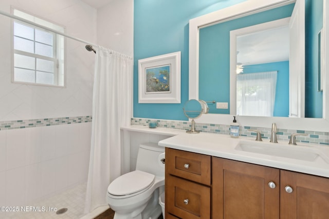 111 Cherry St, Neptune Beach, FL 32266 - bathroom with tasteful backsplash, toilet, a shower stall, ceiling fan, and vanity