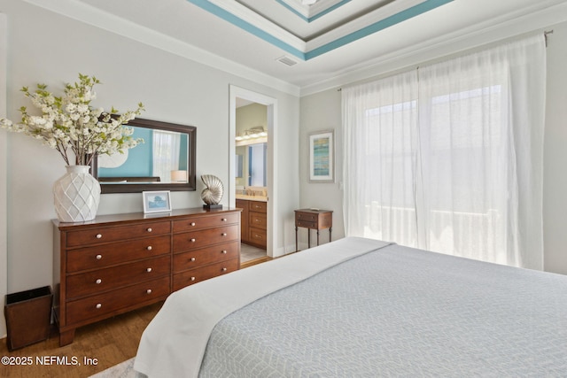 111 Cherry St, Neptune Beach, FL 32266 - bedroom with dark wood finished floors, visible vents, ornamental molding, and connected bathroom