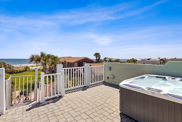 111 Cherry St, Neptune Beach, FL 32266 - view of patio / terrace featuring central AC unit, a hot tub, and a water view
