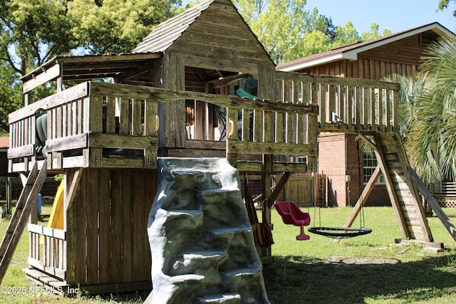 view of playground with a lawn