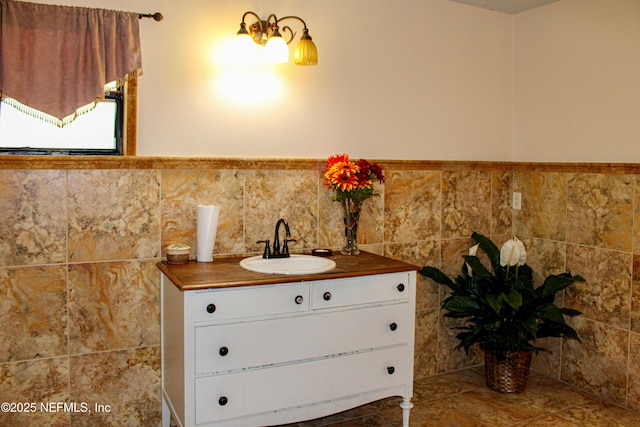 bathroom featuring vanity and a wainscoted wall