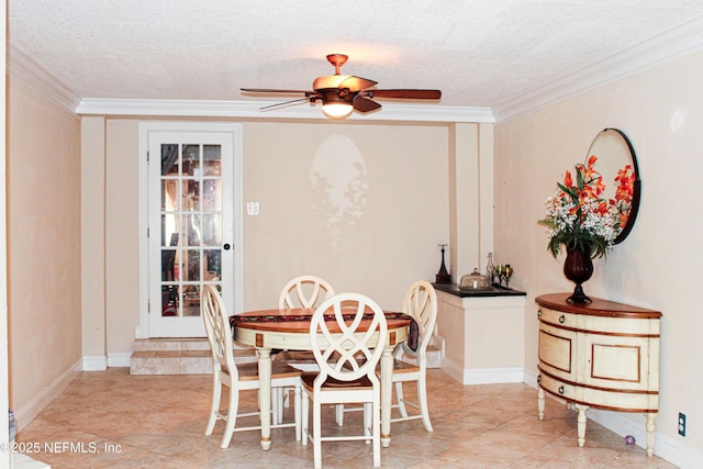 dining area featuring ceiling fan, ornamental molding, and a textured ceiling