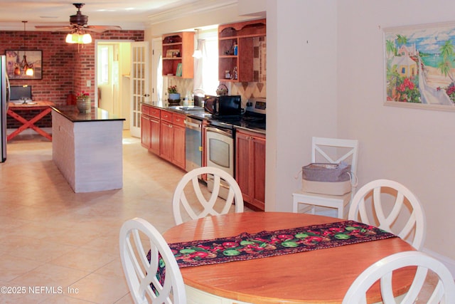 kitchen featuring open shelves, dark countertops, a center island, appliances with stainless steel finishes, and ceiling fan
