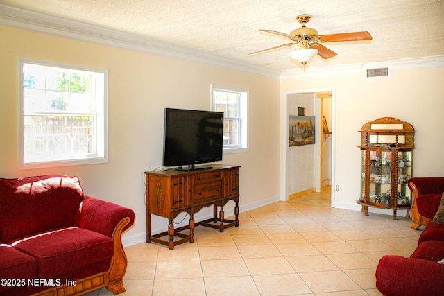 living area with a ceiling fan, ornamental molding, light tile patterned flooring, and visible vents