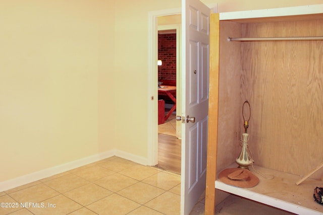 bathroom with baseboards and tile patterned floors