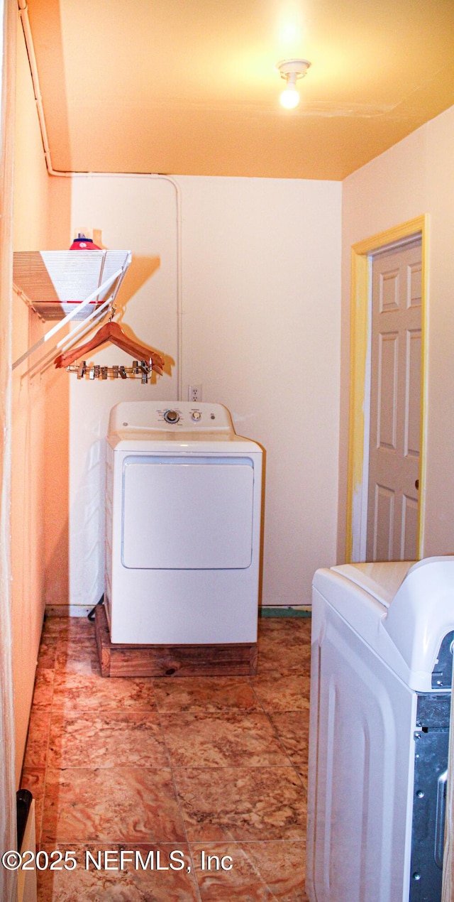 laundry room featuring separate washer and dryer and laundry area