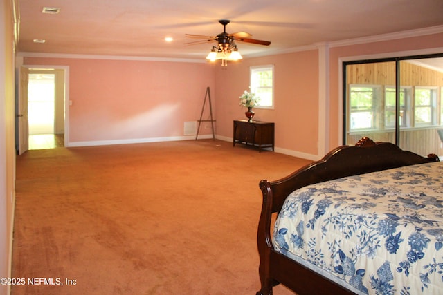 bedroom with a ceiling fan, baseboards, crown molding, and carpet