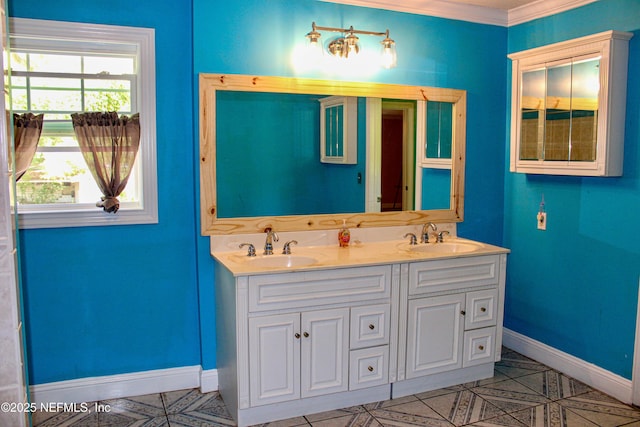 full bathroom with double vanity, baseboards, ornamental molding, and a sink