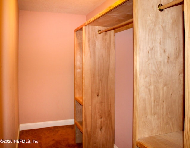 bathroom featuring baseboards and a shower