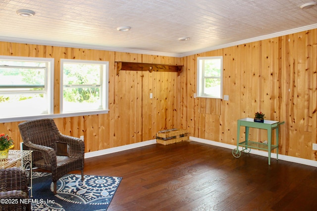 unfurnished room featuring wood-type flooring, a wealth of natural light, ornamental molding, and baseboards