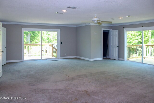 unfurnished living room with carpet floors, visible vents, baseboards, and ornamental molding