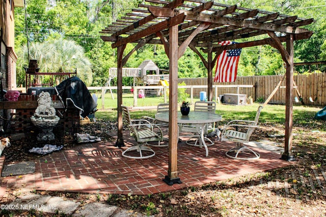view of patio with a pergola, a fenced backyard, a playground, and outdoor dining area