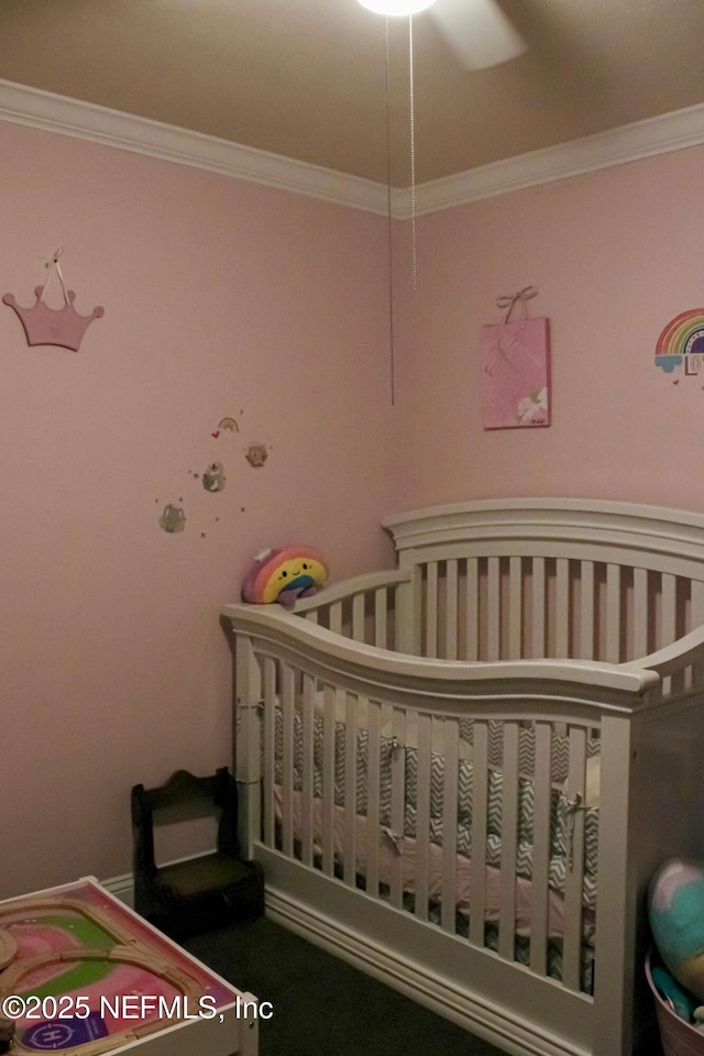 bedroom featuring a nursery area and crown molding