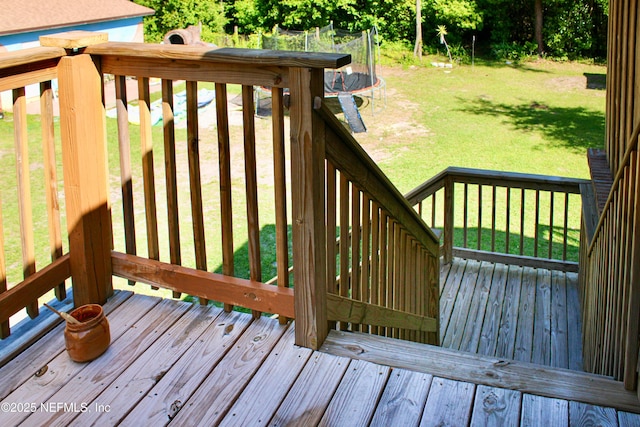 deck featuring a yard and a trampoline