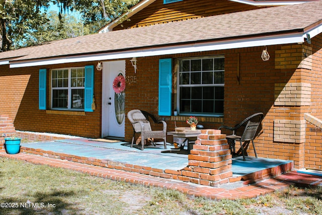 rear view of property with brick siding